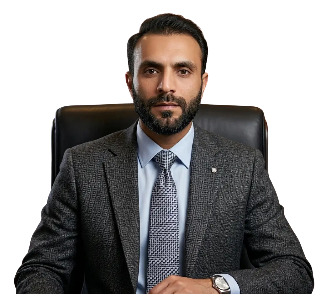 Professional headshot of Ali Niaz, expert website developer, at his workstation in a modern office setting.